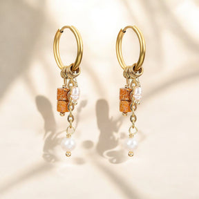 Boucles d'oreilles en forme de goutte avec un anneau en rouille dorée