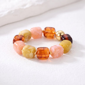 Bracelet épais à breloques mélangées, teintes de braise automnale